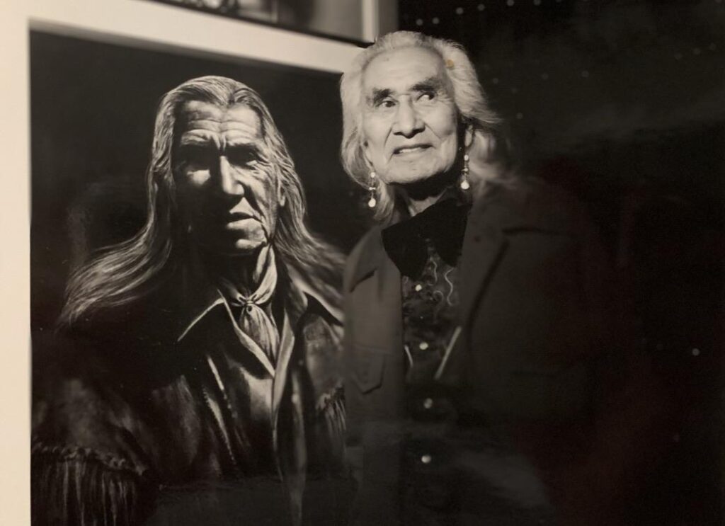 Chief Dan George in front of Geronimo painting by Paul Ygartua