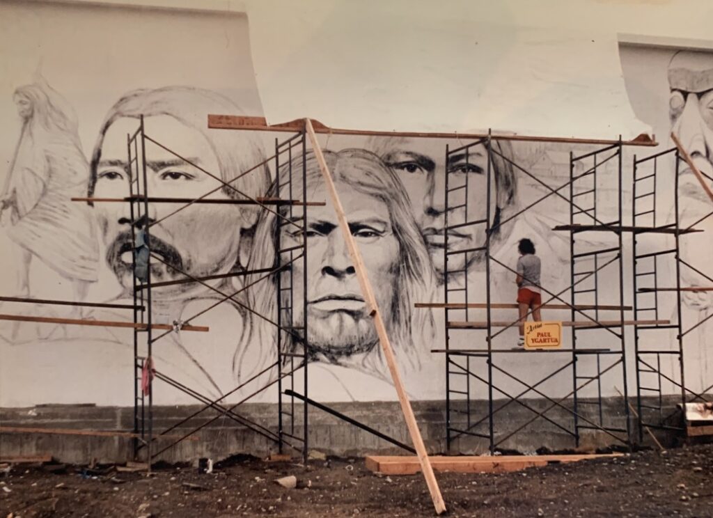 Paul Ygartua working on mural